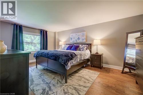 Bedroom featuring wood-finish flooring, a window with exterior views, and neutral wall tones - 41 Mcniven Road, Ancaster, ON - Indoor Photo Showing Bedroom