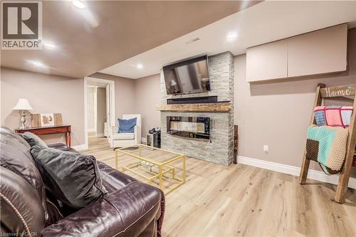 Recreation room featuring wood-finish flooring, recessed lighting, and neutral wall tones - 41 Mcniven Road, Ancaster, ON - Indoor With Fireplace