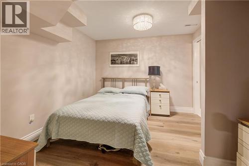 Light wood-finish flooring complements the neutral wall tones - 41 Mcniven Road, Ancaster, ON - Indoor Photo Showing Bedroom