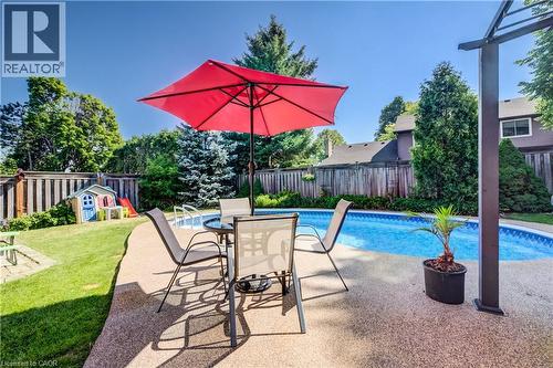 Backyard featuring a built-in swimming pool with a textured aggregate deck - 41 Mcniven Road, Ancaster, ON - Outdoor With In Ground Pool With Backyard