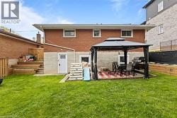 Spacious Backyard featuring new staircase and retaining walls, fully-fenced, with a gazebo and shed - 