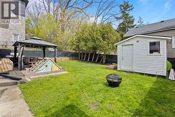 Spacious Backyard featuring new staircase and retaining walls, fully-fenced, with a gazebo and shed - 