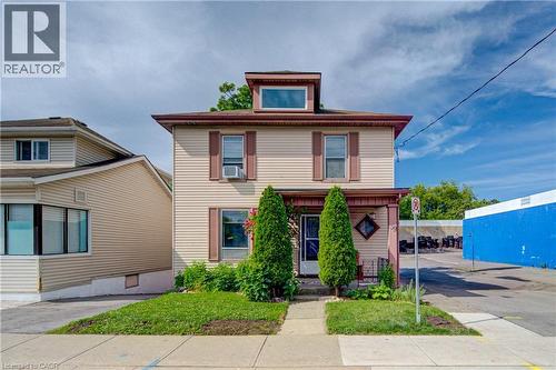 Two-story home with light-colored siding, a dormer window, and a covered front porch - 39 Kerr Street, Cambridge, ON - Outdoor With Facade