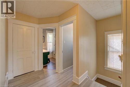 Hallway featuring wood-finish flooring, white paneled doors, and a window with white trim - 39 Kerr Street, Cambridge, ON - Indoor Photo Showing Other Room
