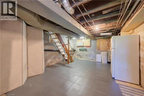 Basement area featuring gray tile flooring and exposed overhead joists - 39 Kerr Street, Cambridge, ON - Indoor Photo Showing Basement