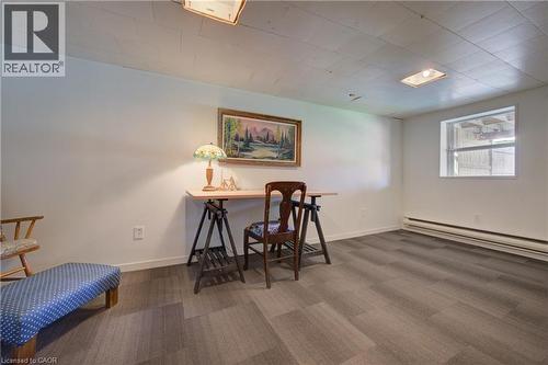 Room featuring wood-finish plank flooring, white painted walls, and a window providing natural light - 39 Kerr Street, Cambridge, ON - Indoor