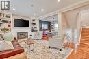Living area featuring a built-in fireplace, recessed lighting, hardwood flooring, built-in shelving, and crown molding - 851 Beach Boulevard, Hamilton, ON  - Indoor Photo Showing Living Room With Fireplace 