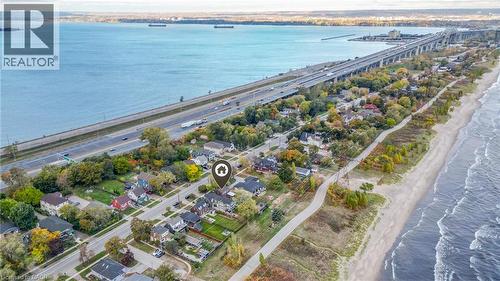 Property featuring direct water frontage with a sandy beach and a paved multi-use trail - 851 Beach Boulevard, Hamilton, ON - Outdoor With Body Of Water With View