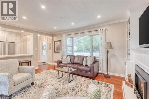 Spacious living area featuring wood-finish flooring, recessed lighting, and crown molding - 851 Beach Boulevard, Hamilton, ON - Indoor Photo Showing Living Room