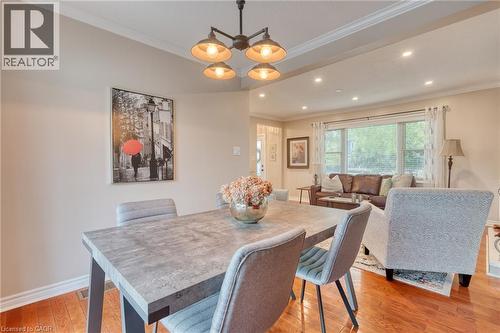 Dining area featuring a modern four-light chandelier, recessed lighting, and crown molding - 851 Beach Boulevard, Hamilton, ON - Indoor Photo Showing Dining Room