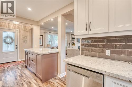 Modern kitchen featuring white upper cabinetry and a stainless steel dishwasher - 851 Beach Boulevard, Hamilton, ON - Indoor Photo Showing Kitchen