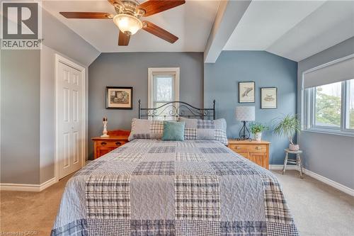 Bedroom featuring neutral carpeting, a bi-fold closet door, and a ceiling fan with light fixture - 851 Beach Boulevard, Hamilton, ON - Indoor Photo Showing Bedroom