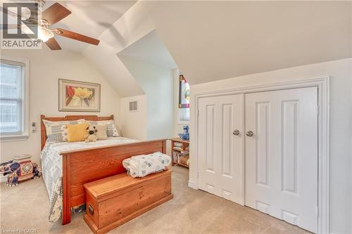 Carpeted room with a ceiling fan, sloped ceilings, and a window with blinds - 851 Beach Boulevard, Hamilton, ON - Indoor Photo Showing Bedroom