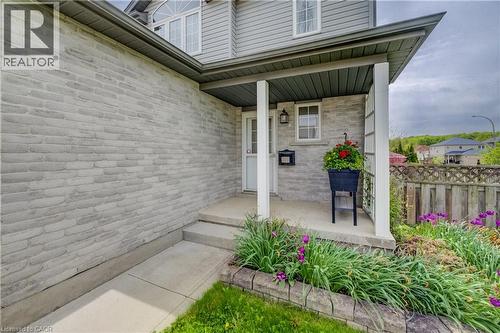 Exterior facade featuring light-toned brickwork and gray siding - 124 Prosperity Drive, Kitchener, ON - Outdoor With Exterior