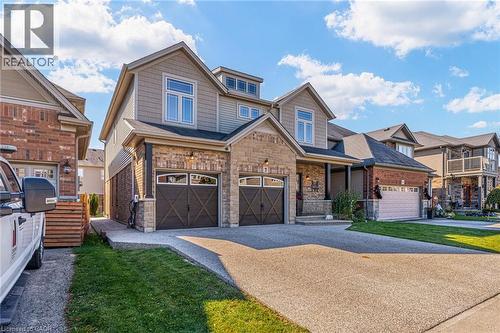 Two-story residential property featuring a mixed material facade with brick and horizontal siding - 7 Kinsman Drive, Binbrook, ON - Outdoor With Facade