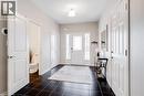 Entry foyer featuring dark square floor tiles, a white front door with decorative glass inserts, and an overhead flush-mount light fixture - 7 Kinsman Drive, Binbrook, ON  - Indoor Photo Showing Other Room 