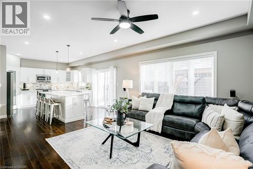 Open-concept living space featuring rich wood-finish flooring, recessed lighting, and a modern ceiling fan - 7 Kinsman Drive, Binbrook, ON - Indoor Photo Showing Living Room