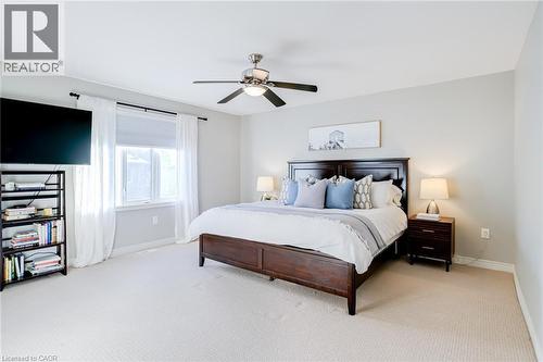 Spacious room featuring light-colored carpeting and a window with white drapery - 7 Kinsman Drive, Binbrook, ON - Indoor Photo Showing Bedroom