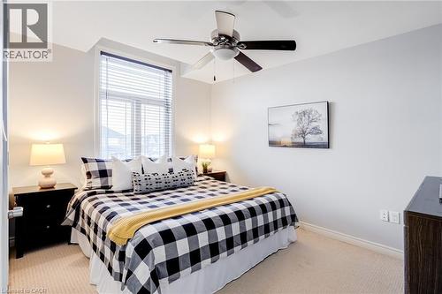 Carpeted room with a ceiling fan, a window with blinds, and white walls - 7 Kinsman Drive, Binbrook, ON - Indoor Photo Showing Bedroom
