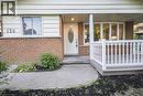 Brick facade with light-colored siding, a covered front porch featuring white railings, and a curved concrete walkway - 124 Dunsmere Drive, Kitchener, ON  - Outdoor With Deck Patio Veranda 