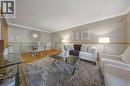 Open-concept living and dining area featuring wood-finish flooring, crown molding, and a neutral color palette - 124 Dunsmere Drive, Kitchener, ON  - Indoor Photo Showing Living Room 