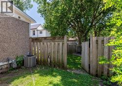 Private fenced yard with mature trees and a lattice-topped wood fence - 