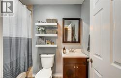 Bathroom vanity with a white countertop and wood-finish cabinetry - 