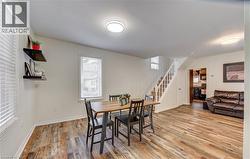Spacious interior featuring wood-finish flooring, white walls, and bright overhead lighting - 