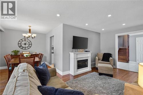 Living space featuring recessed lighting, a white fireplace surround with an electric insert, and wood-finish flooring - 1172 Chada Avenue, Mississauga, ON - Indoor Photo Showing Living Room With Fireplace