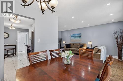 Dining area featuring a dark wood-finish table and chandelier - 1172 Chada Avenue, Mississauga, ON - Indoor Photo Showing Dining Room