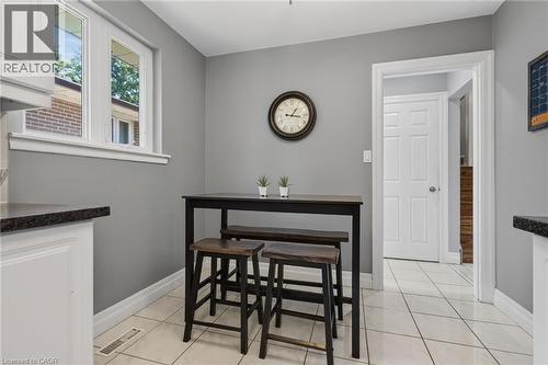 Eat-in kitchen featuring light gray walls, white baseboards, and white tile flooring - 1172 Chada Avenue, Mississauga, ON - Indoor