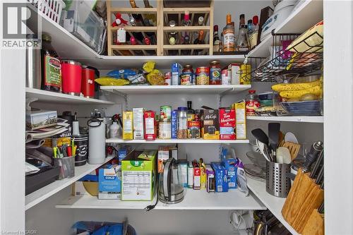 Pantry featuring white shelving, a built-in wine rack, and ample storage space - 1172 Chada Avenue, Mississauga, ON - Indoor With Storage