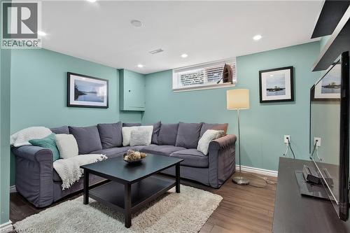 Lower-level living space featuring wood-finish flooring and recessed lighting - 1172 Chada Avenue, Mississauga, ON - Indoor