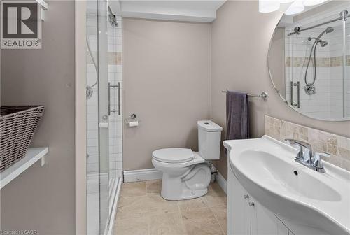 Bathroom featuring a glass-enclosed shower with subway tile, a vanity with an integrated sink, a circular mirror, and tile flooring - 1172 Chada Avenue, Mississauga, ON - Indoor Photo Showing Bathroom