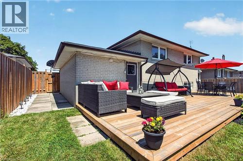 Spacious wood deck extending from the home, featuring a privacy fence, stone paver walkway, and a manicured lawn - 1172 Chada Avenue, Mississauga, ON - Outdoor With Deck Patio Veranda With Exterior