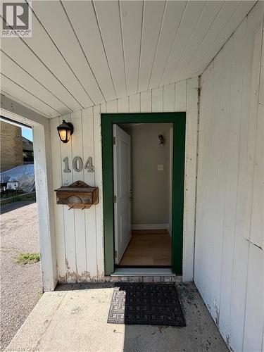 Entryway featuring white vertical siding and a concrete porch - 104 Marshall Street, Waterloo, ON - Outdoor With Exterior