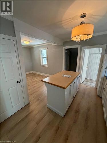 Kitchen island with a butcher block countertop and white cabinetry - 104 Marshall Street, Waterloo, ON - Indoor Photo Showing Other Room