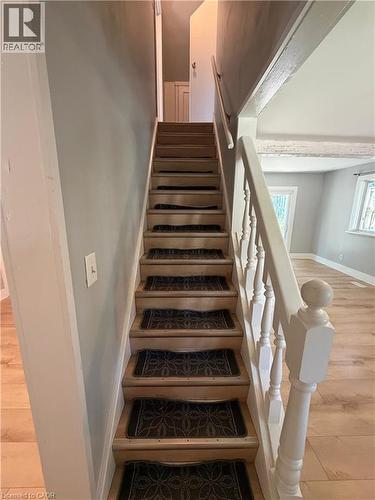 Wooden staircase featuring patterned stair treads and a white painted balustrade - 104 Marshall Street, Waterloo, ON - Indoor Photo Showing Other Room