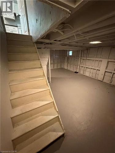 Basement area featuring a concrete floor and exposed ceiling beams - 104 Marshall Street, Waterloo, ON - Indoor