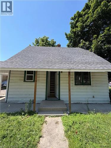 Front exterior featuring a gabled roof with asphalt shingles, light-colored siding, and a covered porch entry - 104 Marshall Street, Waterloo, ON - Outdoor