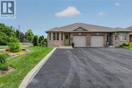 Stone and brick exterior with a prominent bay window - 51 Millcroft Drive, Simcoe, ON - Outdoor With Facade