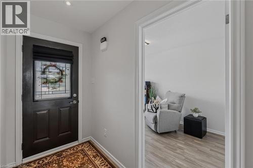 Entryway featuring a dark paneled door with a decorative leaded glass insert and a privacy blind - 51 Millcroft Drive, Simcoe, ON - Indoor Photo Showing Other Room