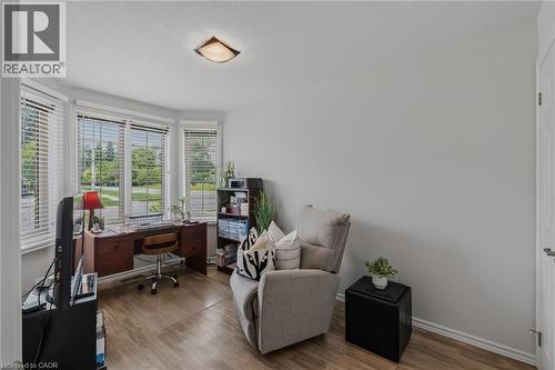Bay window with multiple panels, wood-finish flooring, a neutral wall color, and a flush-mount ceiling light - 51 Millcroft Drive, Simcoe, ON - Indoor Photo Showing Office