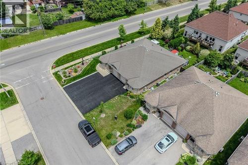 Aerial perspective highlighting a residential property with a multi-car paved driveway - 51 Millcroft Drive, Simcoe, ON - Outdoor With View