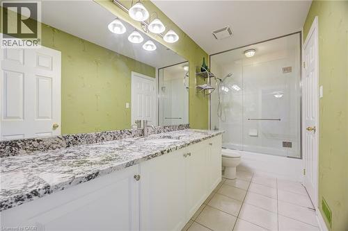 Double vanity featuring a granite countertop, dual undermount sinks, and white cabinetry - 4278 Clubview Drive, Burlington, ON - Indoor Photo Showing Bathroom