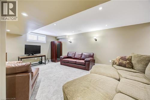 Recreational room featuring recessed lighting, sconce lighting, carpet flooring, and a window with plantation shutters - 4278 Clubview Drive, Burlington, ON - Indoor