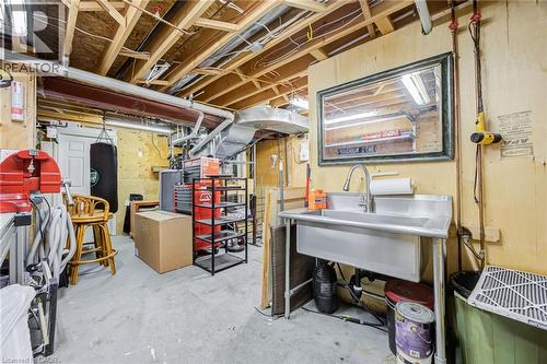 Utility room featuring an exposed ceiling, plywood wall finishes, and concrete flooring - 4278 Clubview Drive, Burlington, ON - Indoor Photo Showing Basement