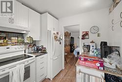 All white appliances & access to dining room. - 