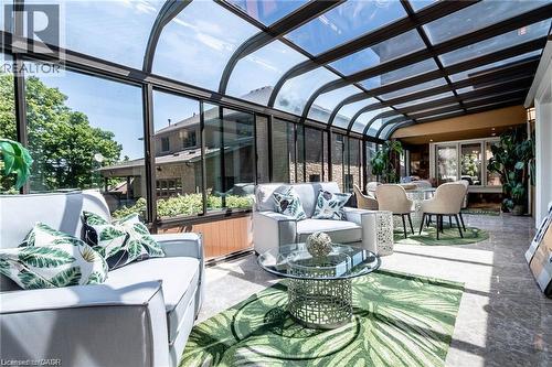 Curved glass ceiling and wall panels provide abundant natural light - 76 Adriatic Boulevard, Hamilton, ON - Outdoor With Deck Patio Veranda