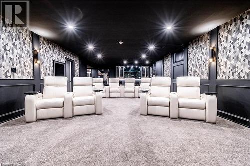 Dedicated media room featuring patterned wall coverings and dark wainscoting - 76 Adriatic Boulevard, Hamilton, ON - Indoor Photo Showing Other Room
